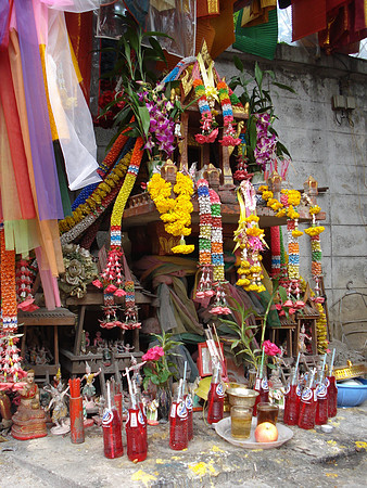 Offerings at a roadside shrine, Bangkok - Thailand.