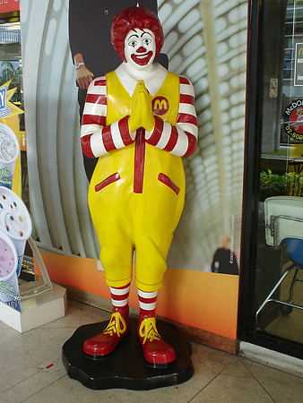 Sawasdee. Ronald McDonald doing the Thai greeting referred to as the wai, Bangkok - Thailand.
