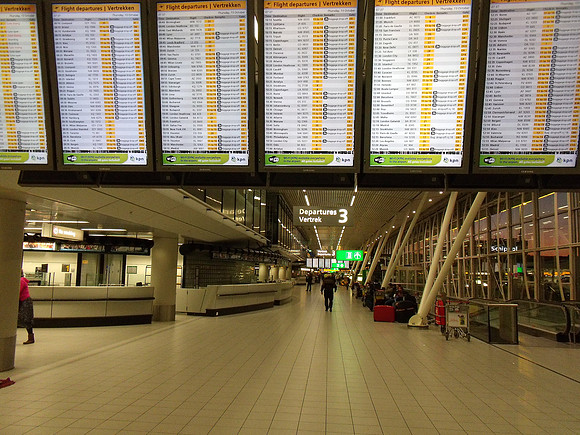 Departure board at Amsterdam Schiphol Airport.